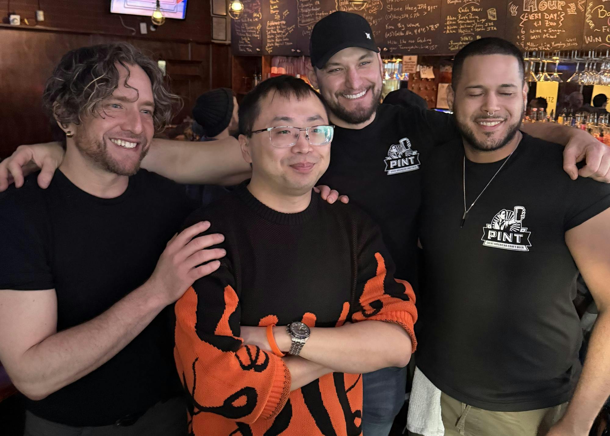 Four men at a bar. 