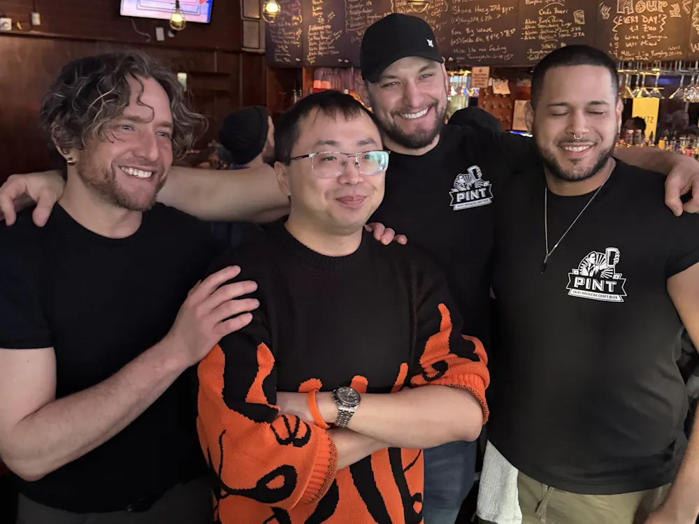 Four men at a bar.