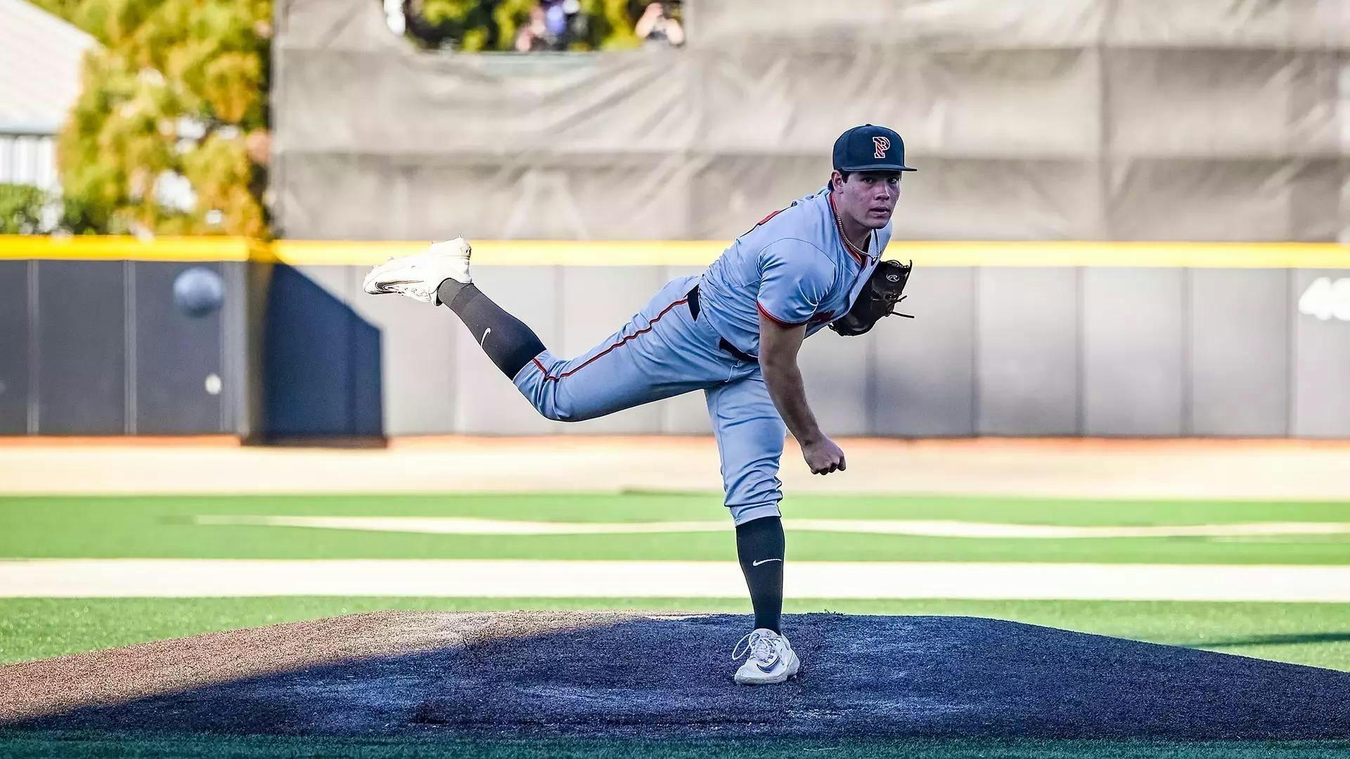 Baseball pitcher throwing the ball on the mound.