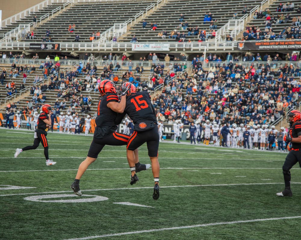 Two Princeton football players celebrate a touchdown.