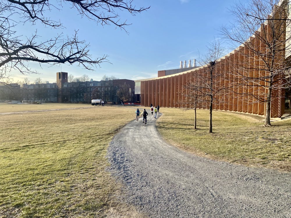 <h5>Pedaling towards progress, the future takes a scenic route through Poe Field, with the Icahn Laboratory as a picturesque backdrop.&nbsp;</h5>
<h6>Guanyi Cao / The Daily Princetonian</h6>