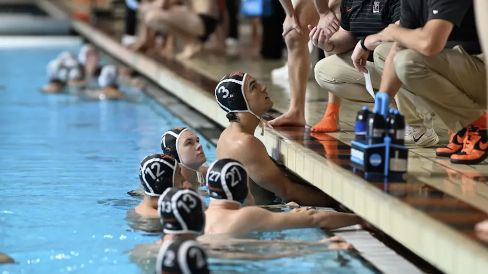 Men’s water polo players huddling up for a game plan.