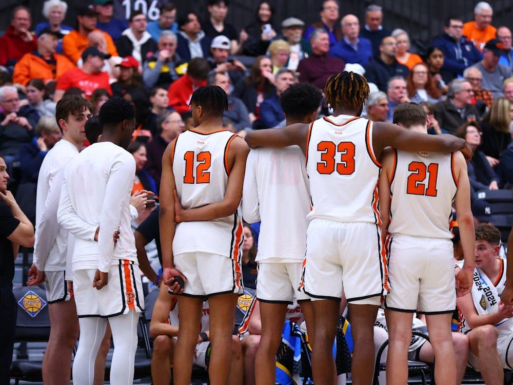 Seven men in white jerseys face away from camera towards their team.