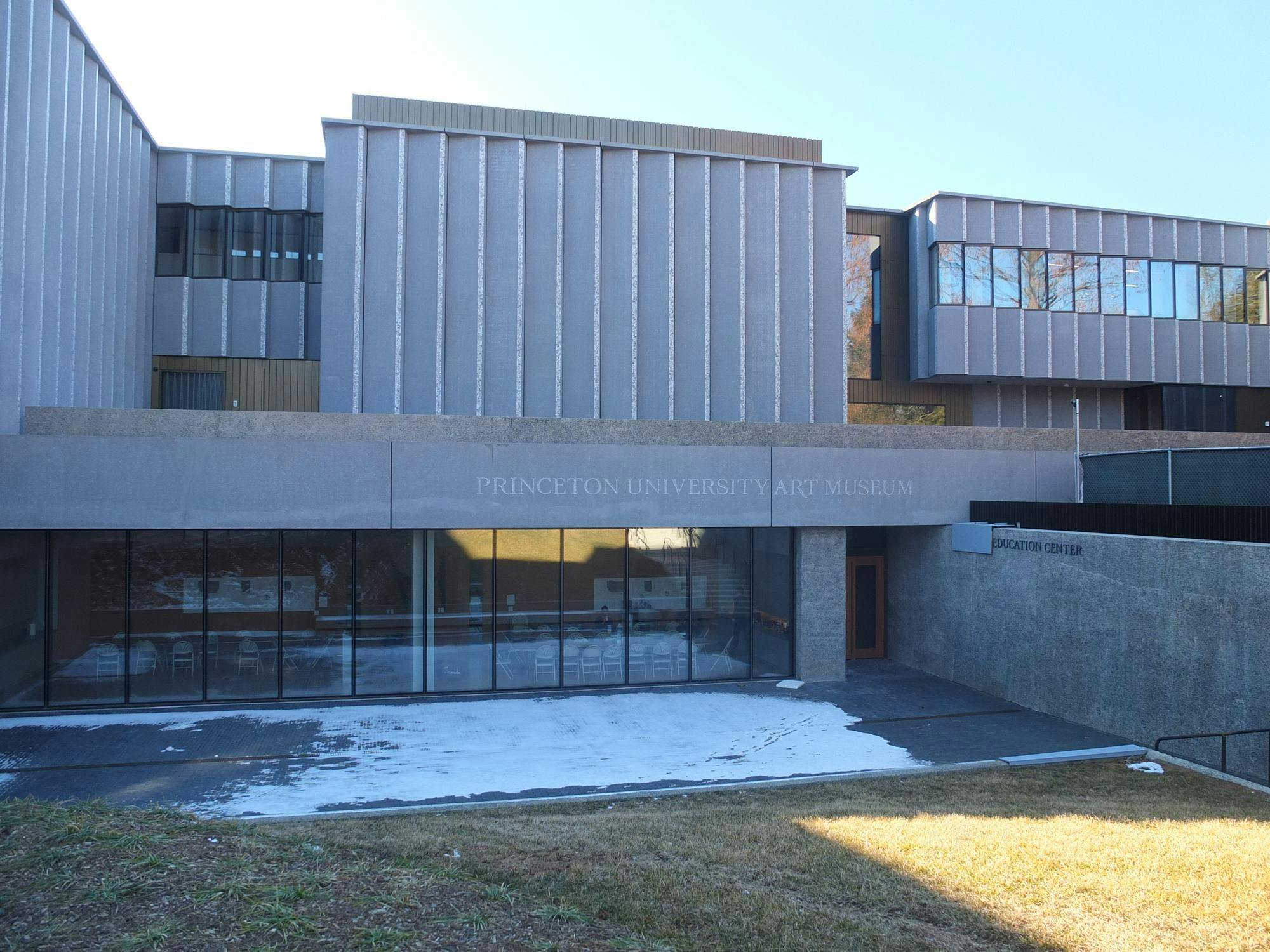 A rectangular grey building with writing featuring "Princeton University Art Museum" and "Education Center" 