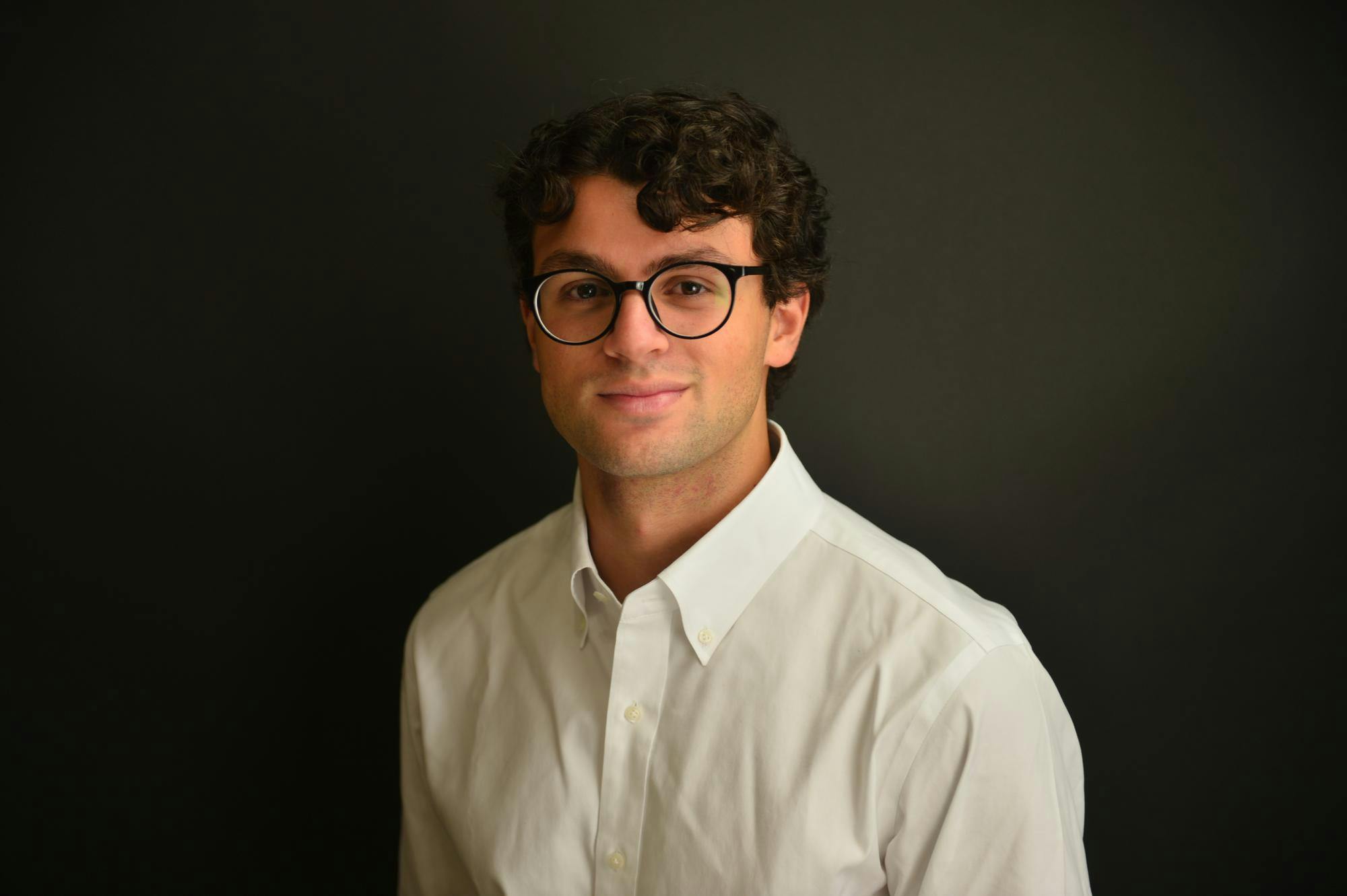 A person wearing glasses and a dress shirt