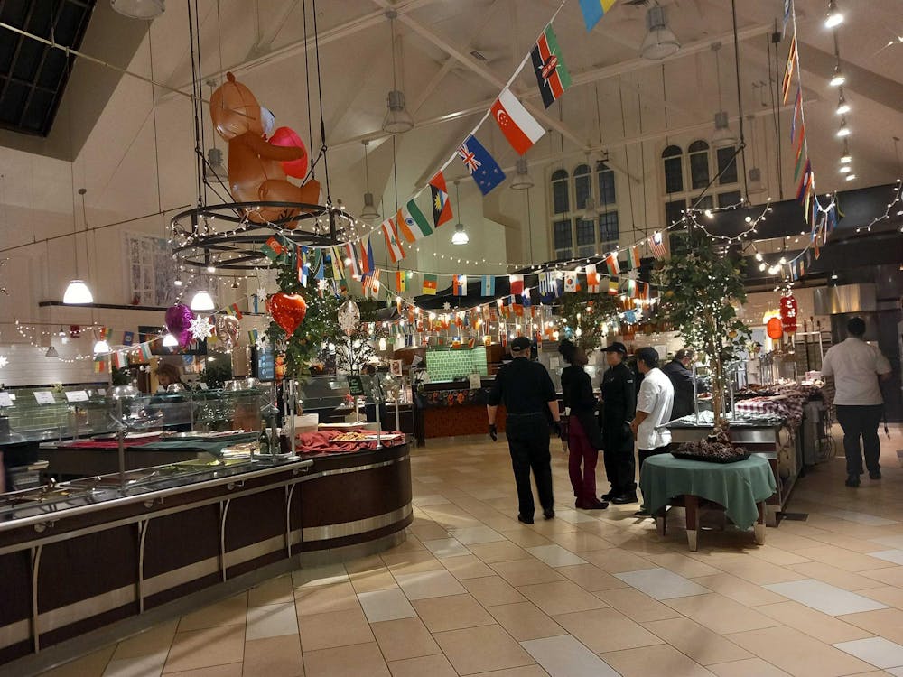 Dining hall servery decorated with flags of different countries on a string over the servery.