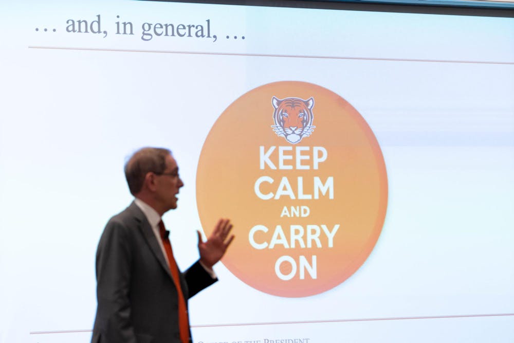 President Eisgruber stands in front of screen with "Keep Calm and Carry on" message.