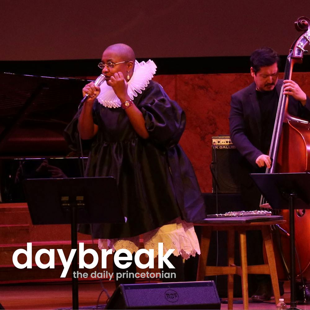 Jazz musician Cécile McLorin Salvant sings onstage in front of the bass player in her band.