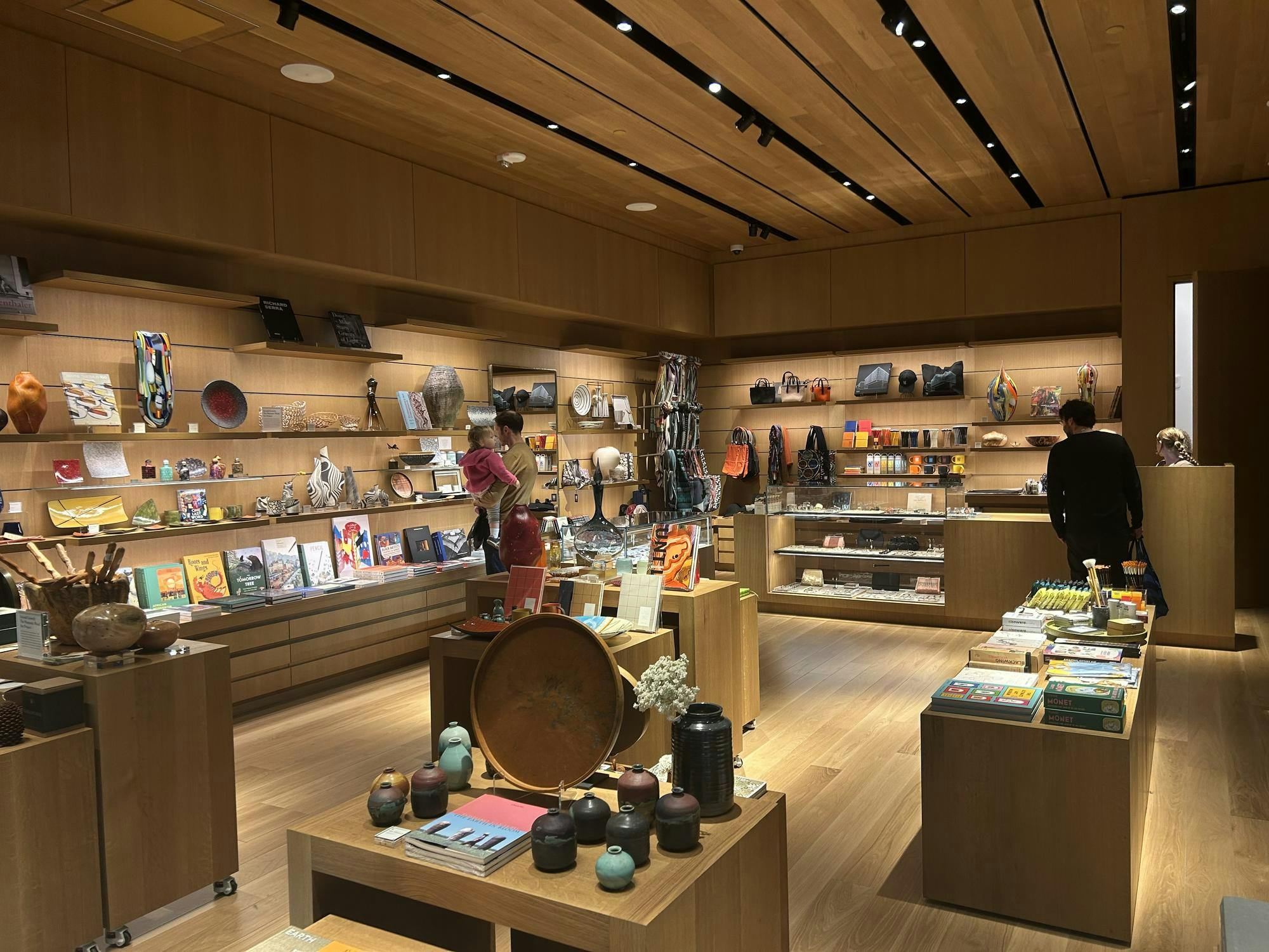 People standing in front of shelves of artistic goods. 