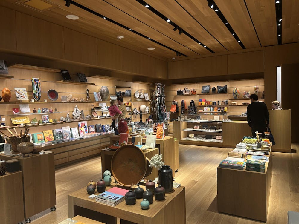 People standing in front of shelves of artistic goods.