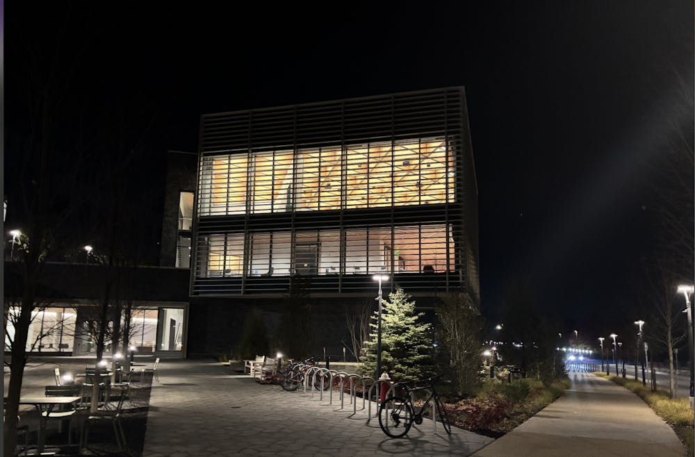 An outside view of Commons Library in the ES & SEAS complex at night. 
