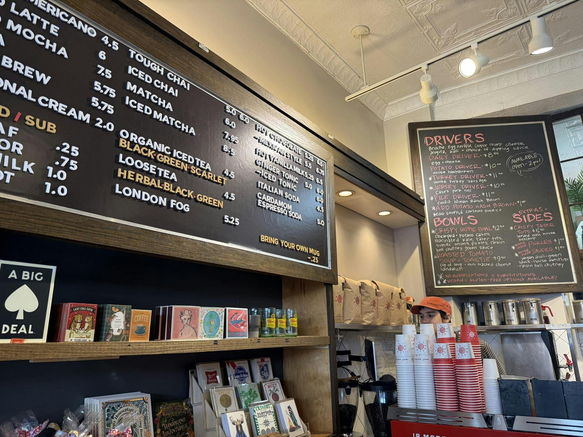 A menu on a blackboard featuring different drinks.