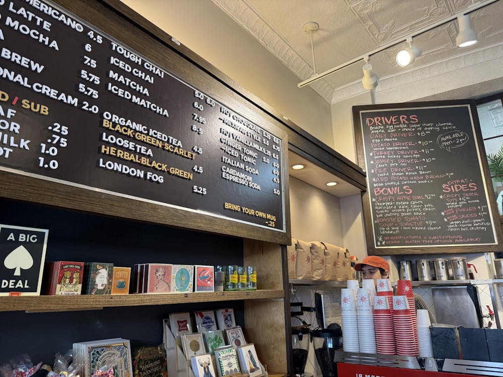 A menu on a blackboard featuring different drinks.