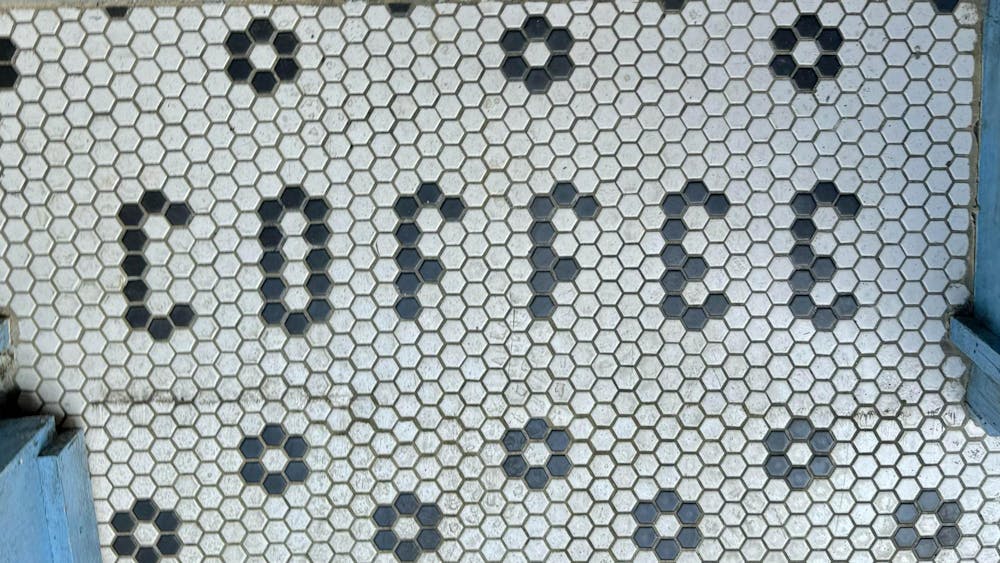 Floor tiles spelling out the word "coffee."
