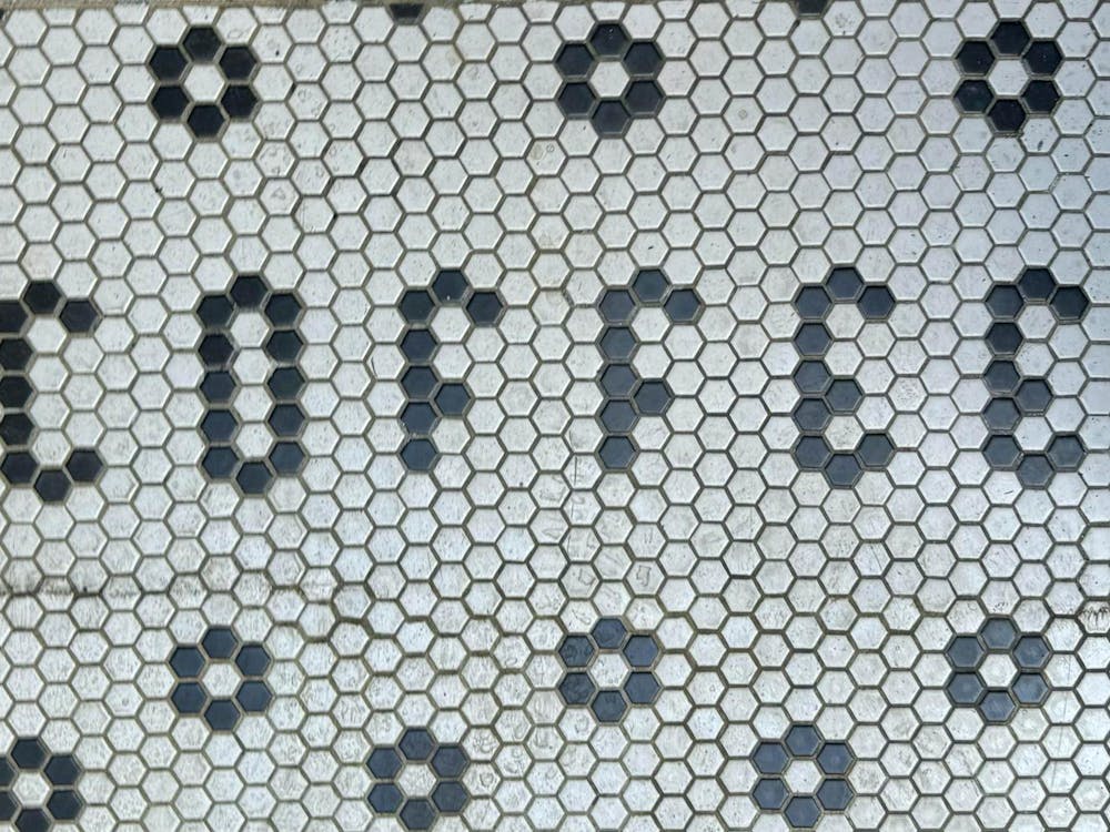 Floor tiles spelling out the word "coffee."