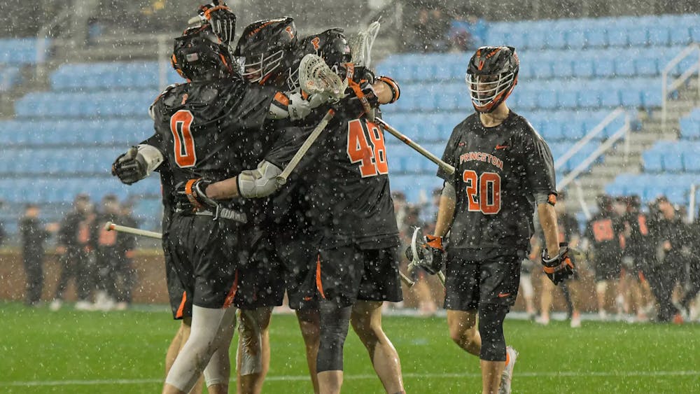 Five Princeton players gather to celebrate after a goal in the rain versus the University of North Carolina. 