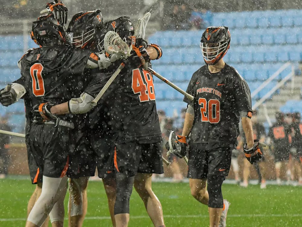 Five Princeton players gather to celebrate after a goal in the rain versus the University of North Carolina. 