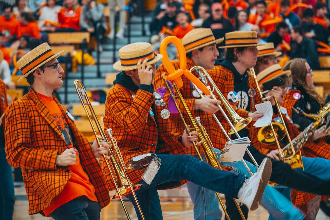 Band, in plaid orange and black jackets, plays in Jadwin Gym.