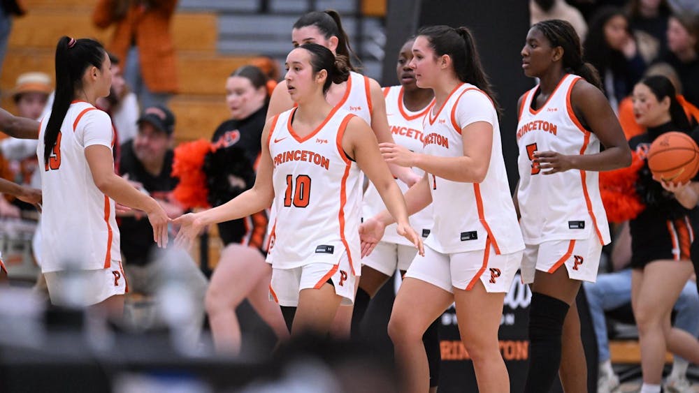 Basketball team walking on court.