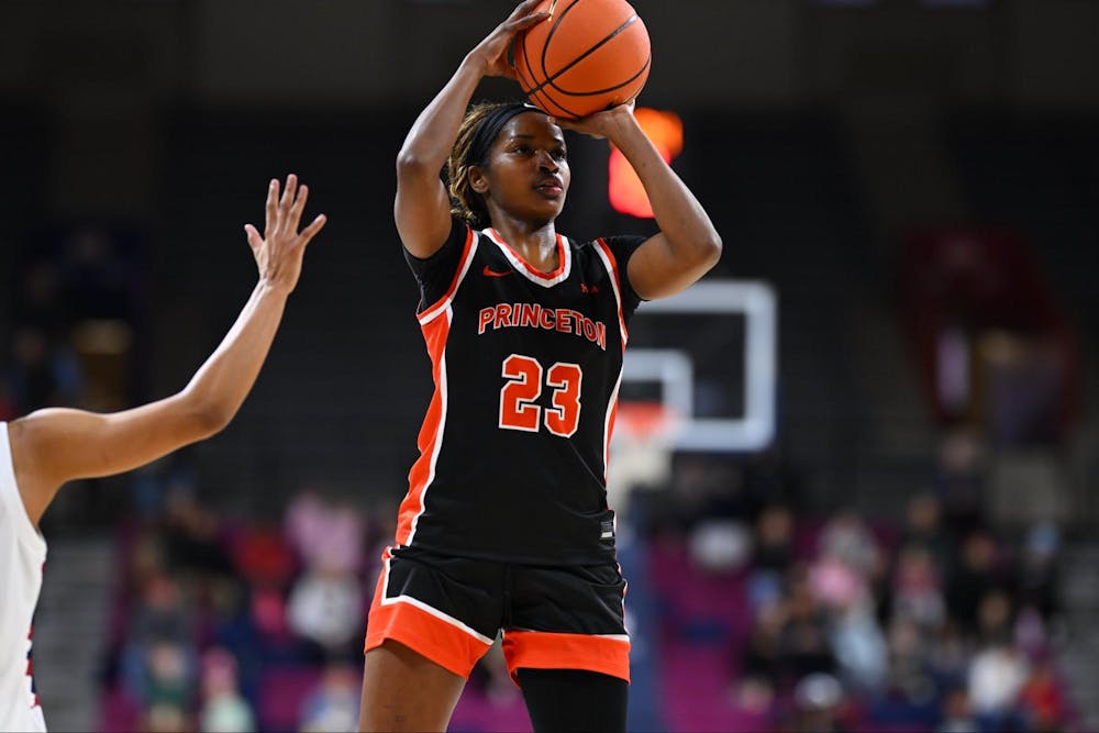Princeton woman basketball player in black jersey shooting a basketball.