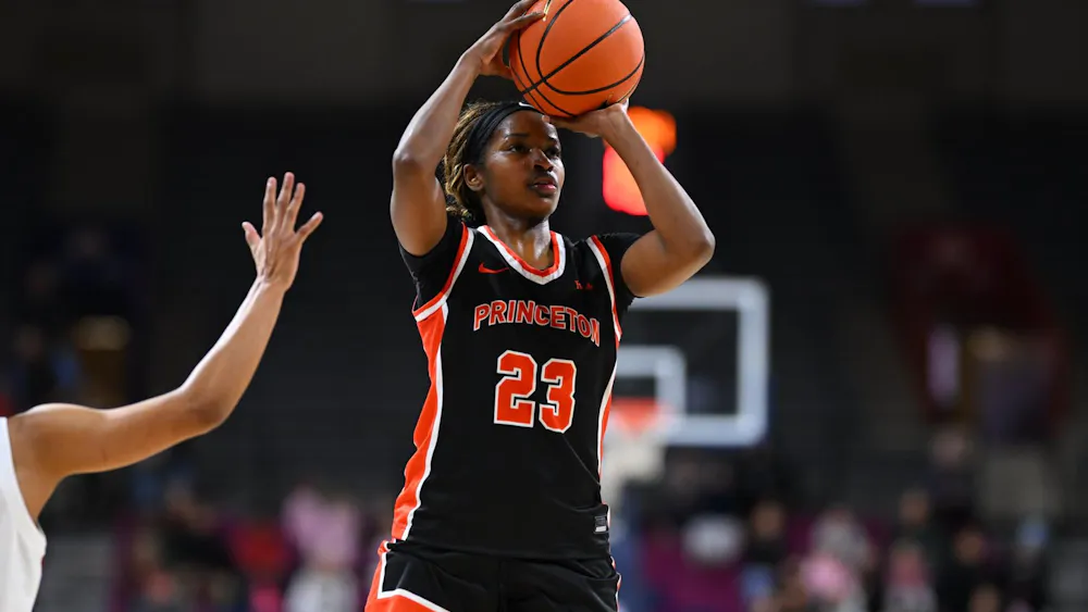 Princeton woman basketball player in black jersey shooting a basketball.
