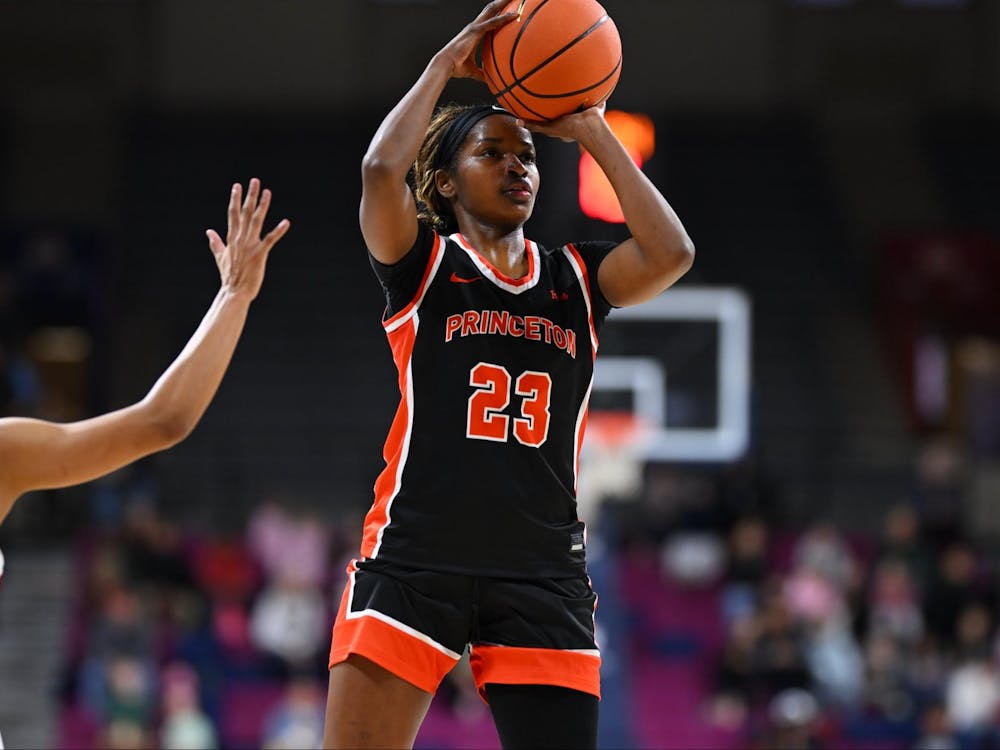 Princeton woman basketball player in black jersey shooting a basketball.
