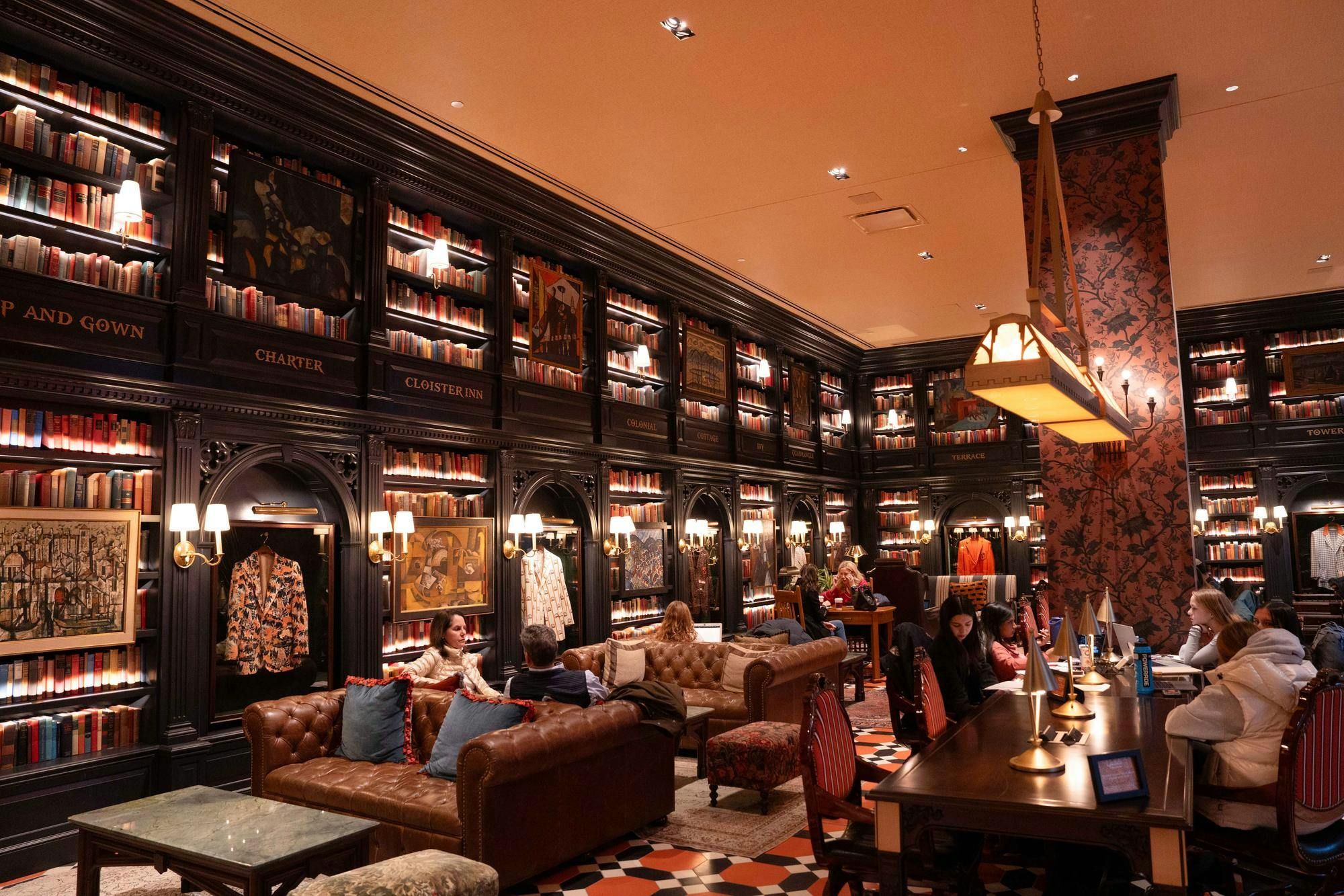 A room lined with bookshelves, Princeton Reunions jackets, ornate furniture, all under a moody lighting. 