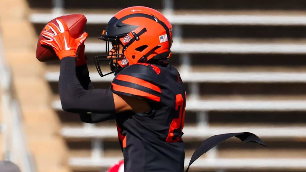 princeton football player catches ball with elbows up and helmet on 