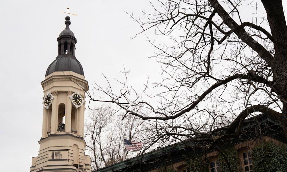 A yellow bell tower. There is an American flag next to it.