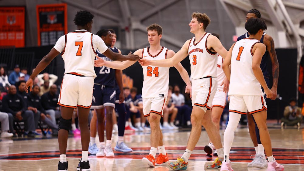 Princeton teammates shake hands in success after beating Monmouth.