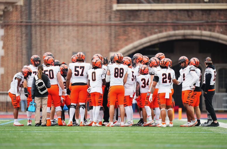 Princeton football team in a huddle.