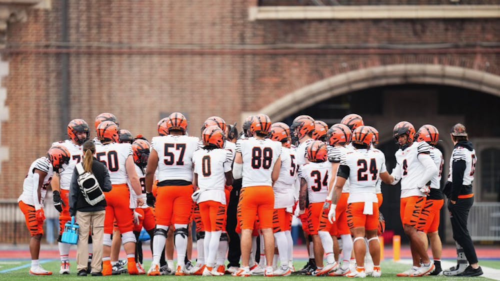 Princeton football team in a huddle.