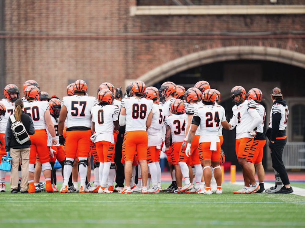 Princeton football team in a huddle.