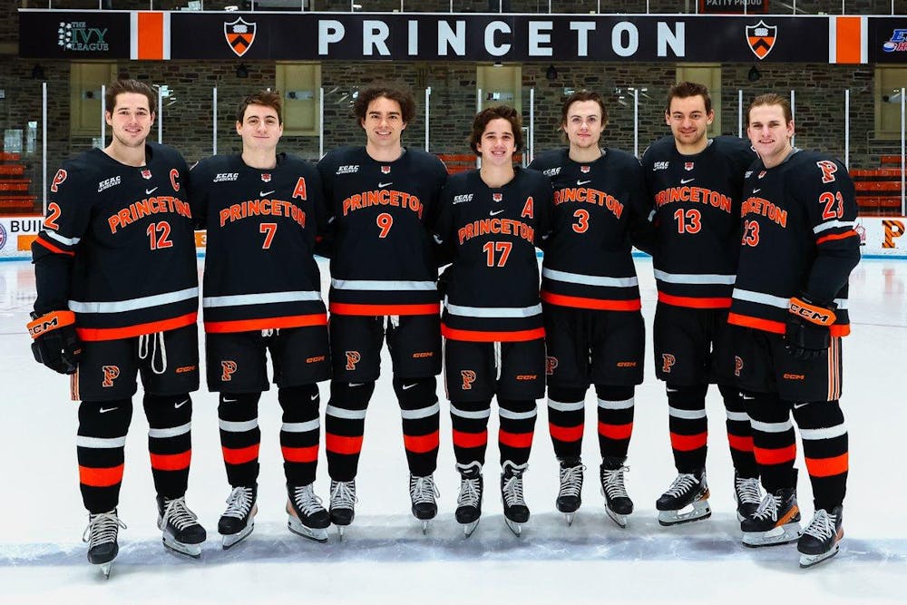 Seven Princeton players pose in a row for photo before their last game at Hobey Baker Rink. 
