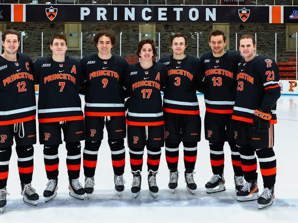 Seven Princeton players pose in a row for photo before their last game at Hobey Baker Rink.