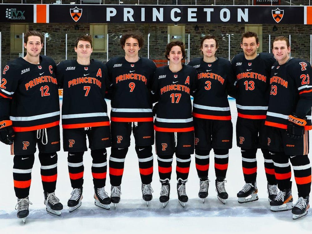 Seven Princeton players pose in a row for photo before their last game at Hobey Baker Rink. 