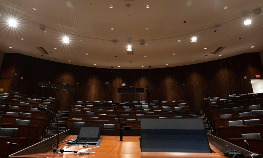An empty auditorium with lights on.