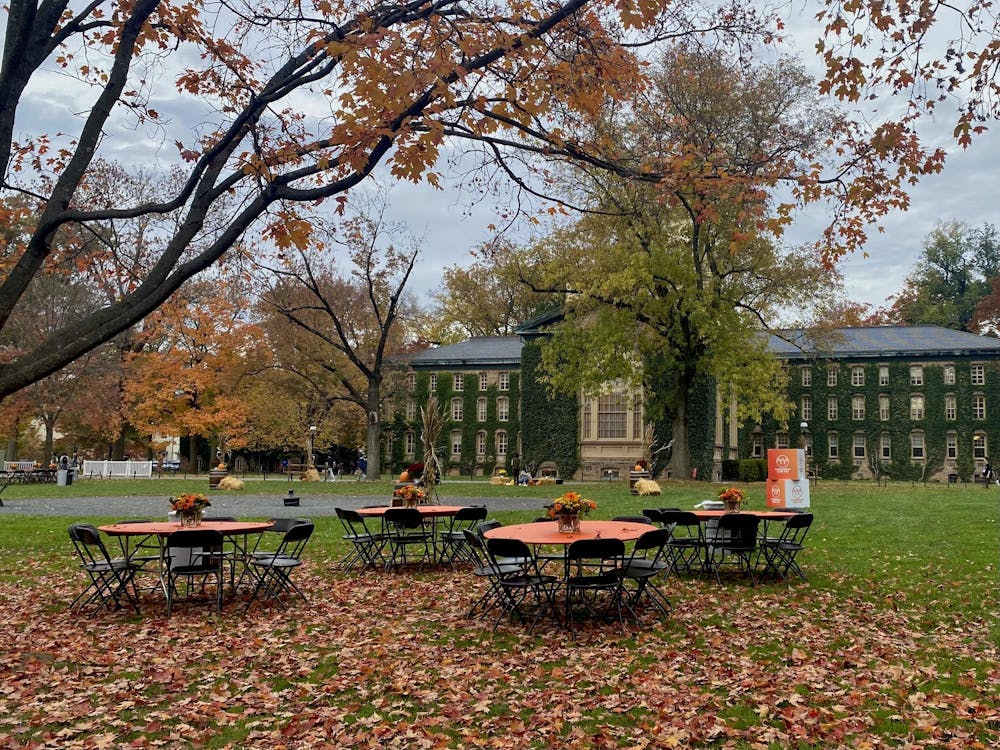 Orange tables are set up in Cannon Green with Nassau Hall in the background.