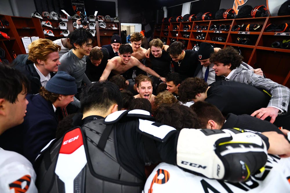 Postgame celebrations by a group of hockey players in a locker room