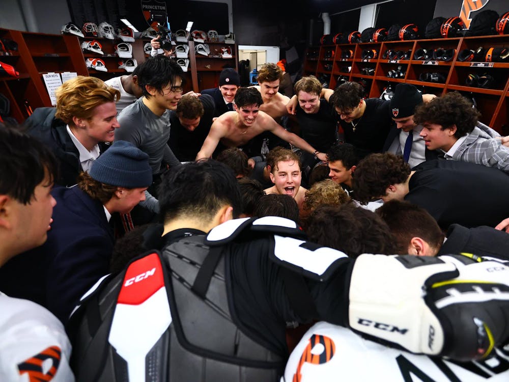 Postgame celebrations by a group of hockey players in a locker room