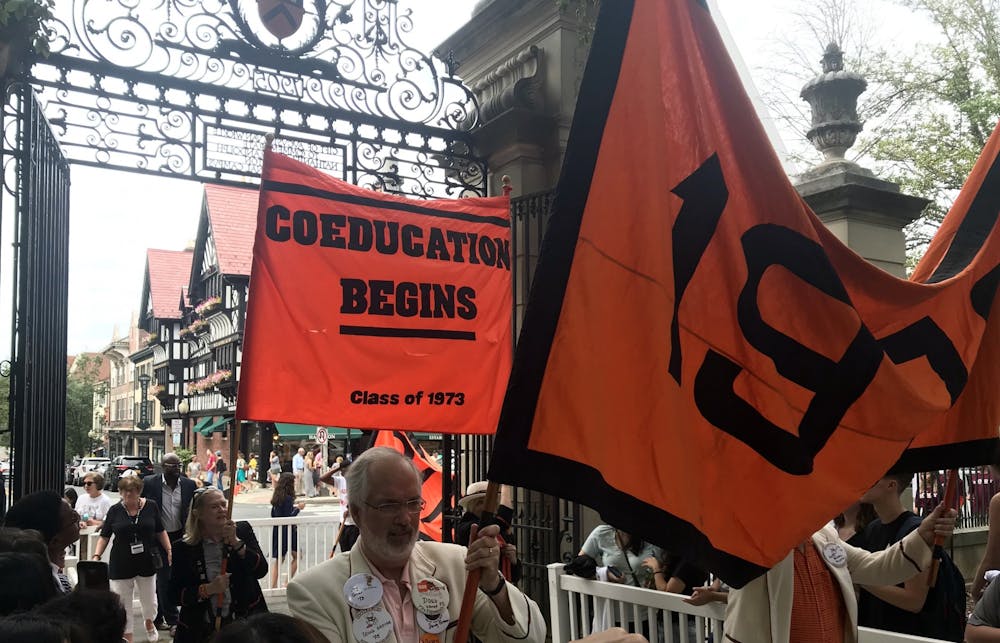 <p>Members of the Class of 1973 hold up a "Coeducation Begins" banner at the Pre-Rade.</p>
<h6>Photo Credit: Zachary Shevin / The Daily Princetonian</h6>