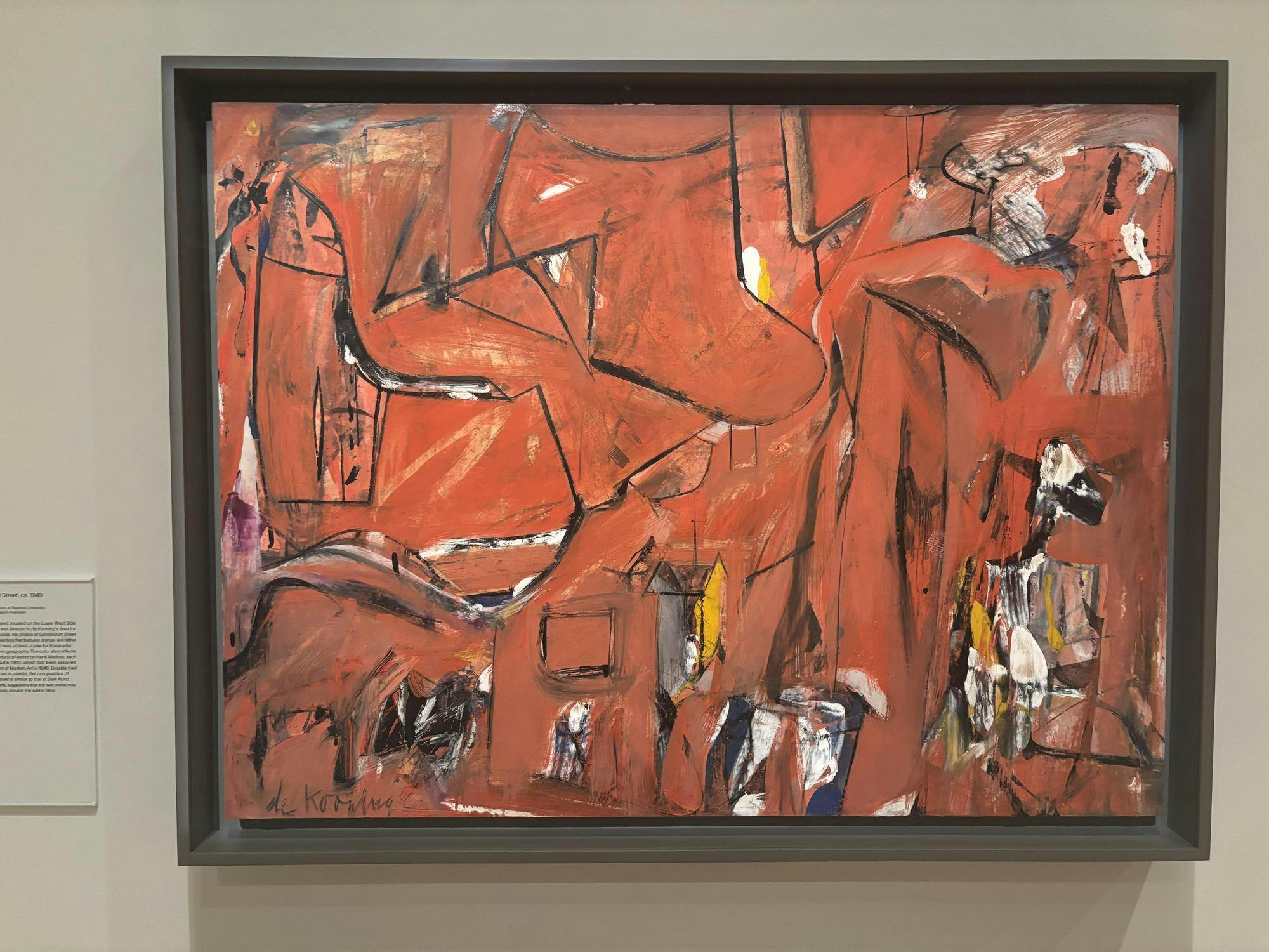 An abstract painting using shades of red and black.