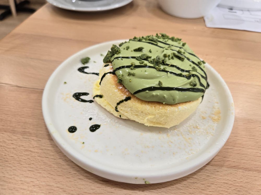 Fluffy pancake with green frosting on top.