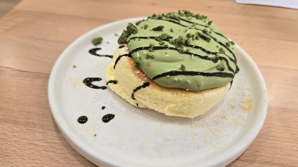 Fluffy pancake with green frosting on top.