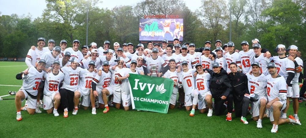 Princeton men's lacrosse team in front of a banner