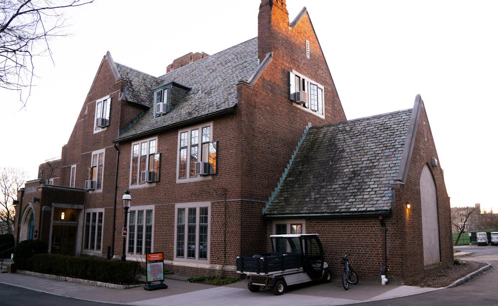 A three-story brick building with the last of the sunset on the side.