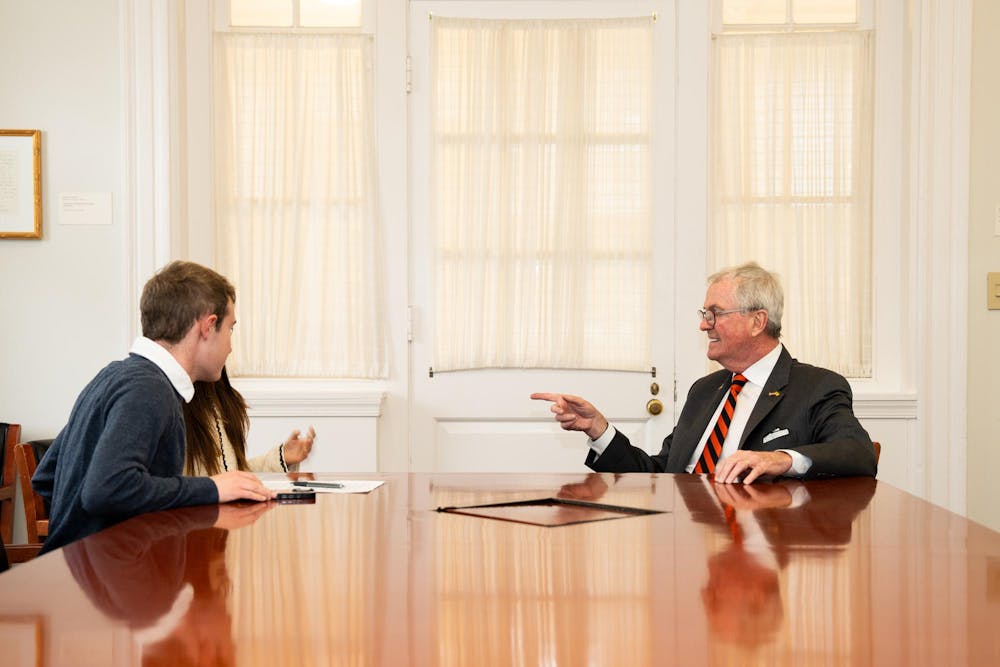 'Prince' reporters Luke Grippo and Sena Chang (left) sitting with Governor Phil Murphy (right) at a table in Joseph Henry House.