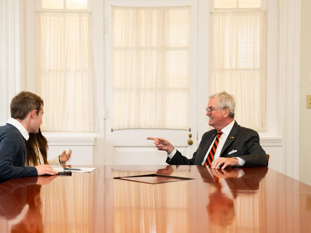 'Prince' reporters Luke Grippo and Sena Chang (left) sitting with Governor Phil Murphy (right) at a table in Joseph Henry House.