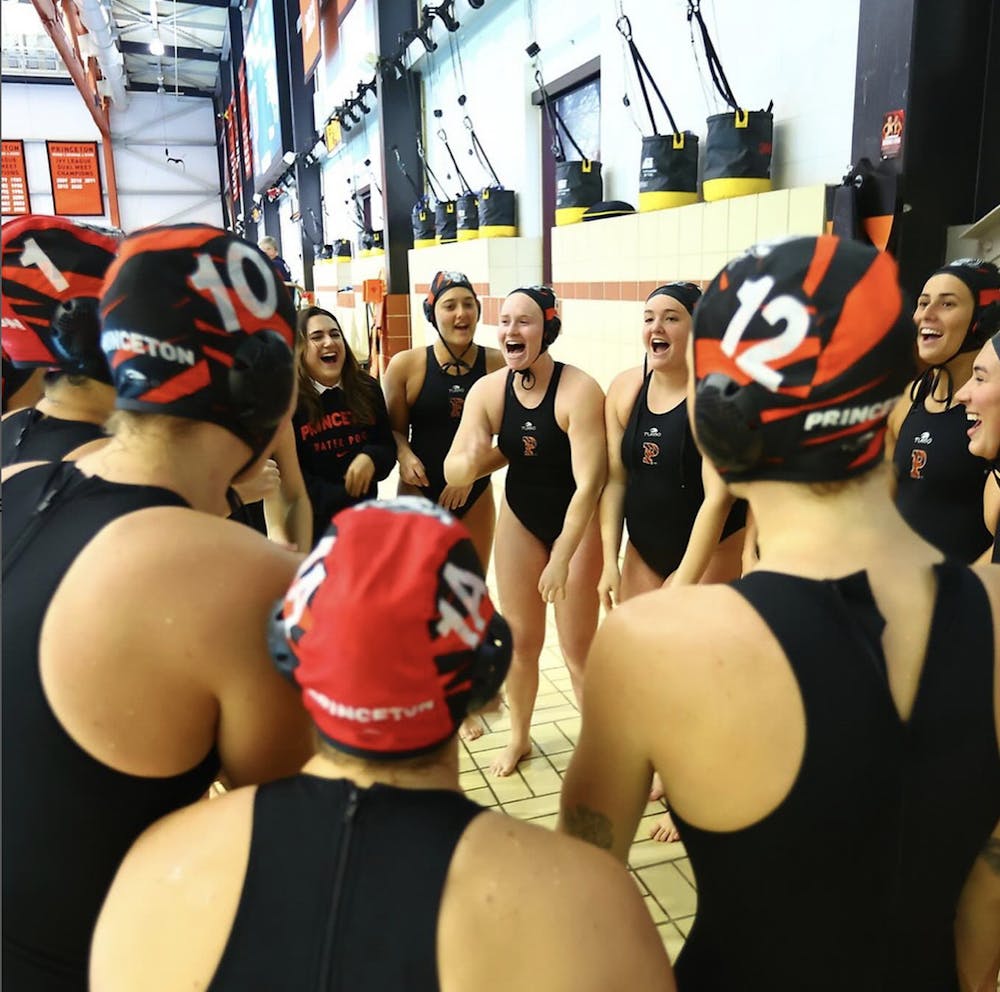 Women in black swimsuits gather in a circle