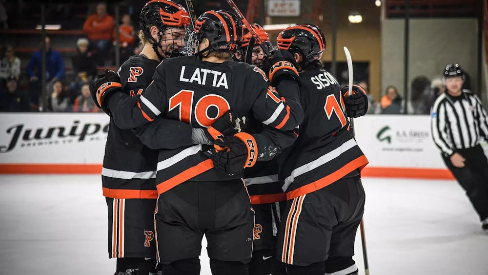Ice hockey players huddling on rink.